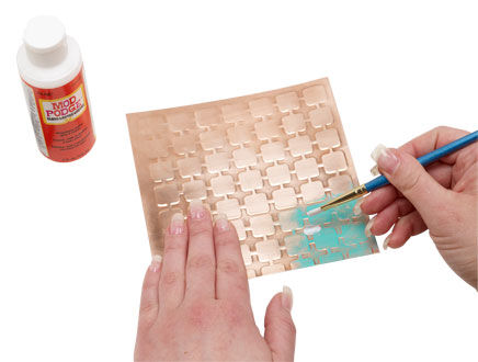 Mod Podge being applied over Gilders paste